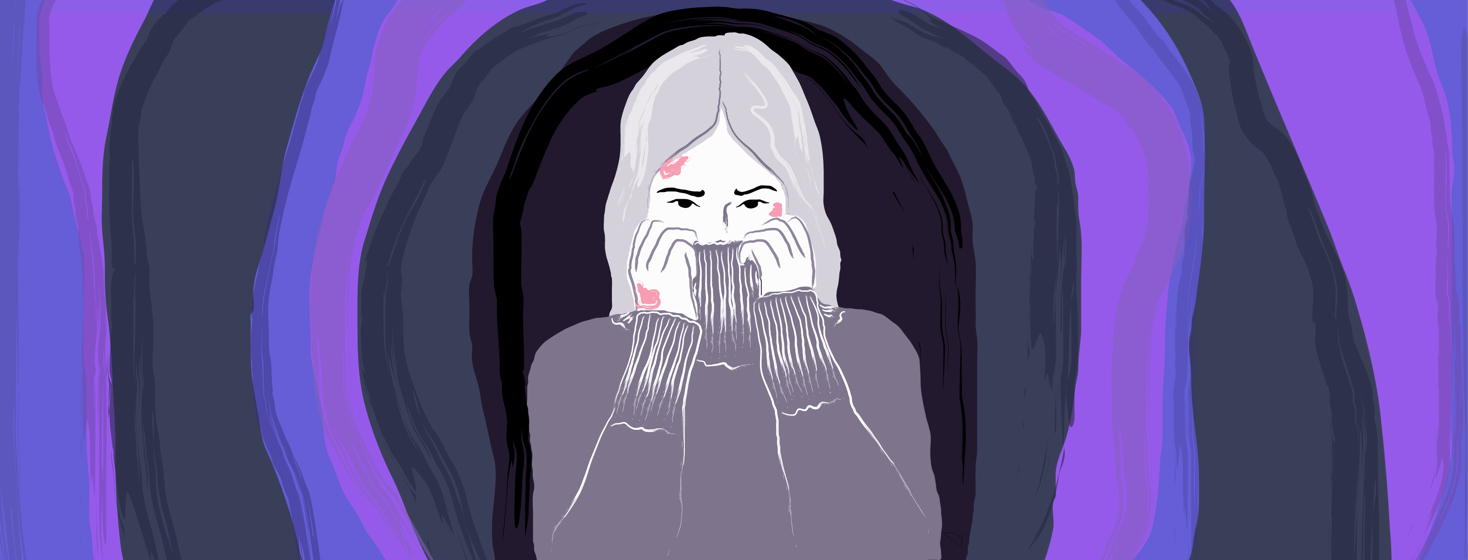 Woman is in the middle of a cave-like tunnel, covering her face with her turtleneck sweater.