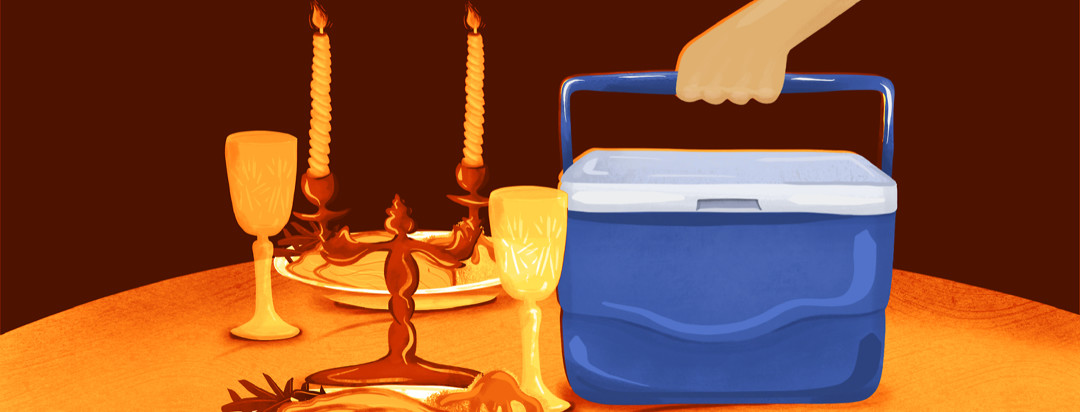 A candlelit table is set for Thanksgiving, while a large cooler is plopped down in the center.