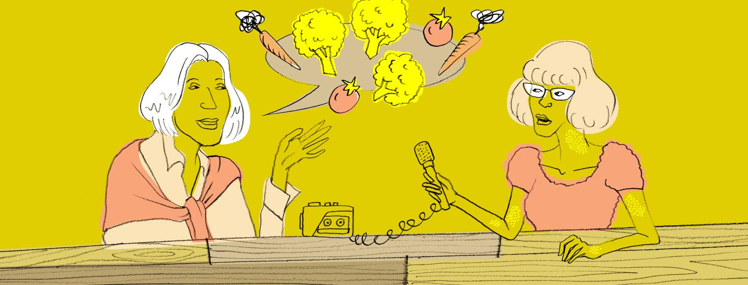 An elderly mother and her daughter sit at a table as the daughter interviews her. A speech bubble containing healthy foods floats above the mother.