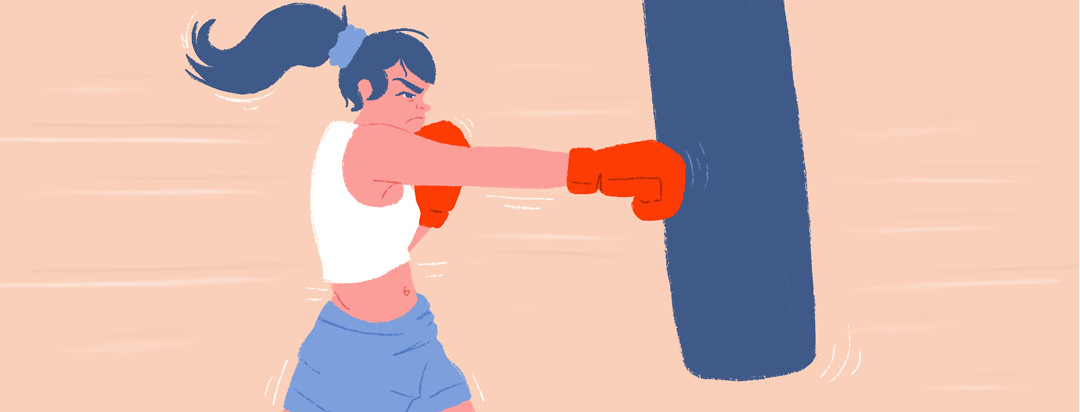 A female boxer spiritedly punches a punching bag with boxing gloves.