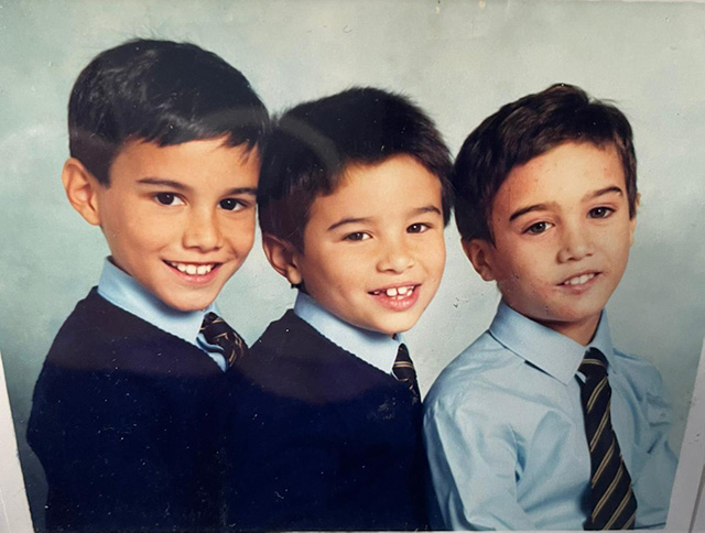 Three boys smiling for a photo portrait together.