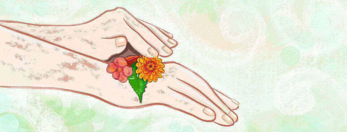 Hands with eczema place flowers on their skin