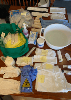 A setup station for wet dressing treatment, the table is covered in gauze and other relevant products